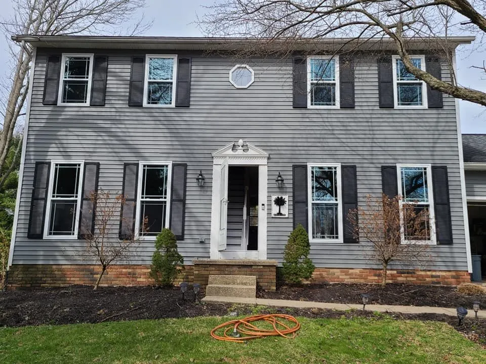 Home exterior with new replacement windows installed by Just Windows USA